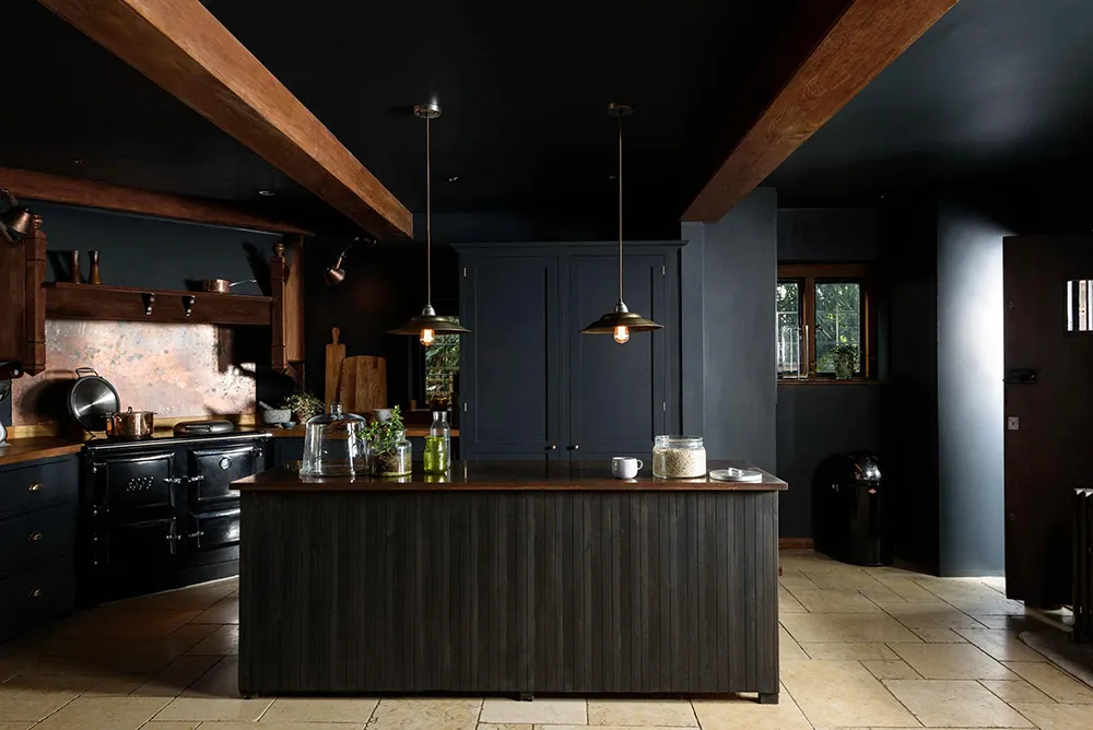 Black kitchen with wood beams