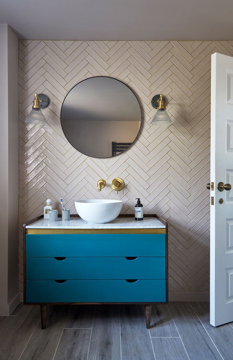 Herringbone pattern tiles with blue vanity contemporary bathroom design