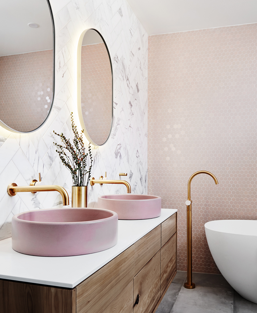 pink and beige bathroom with gold taps