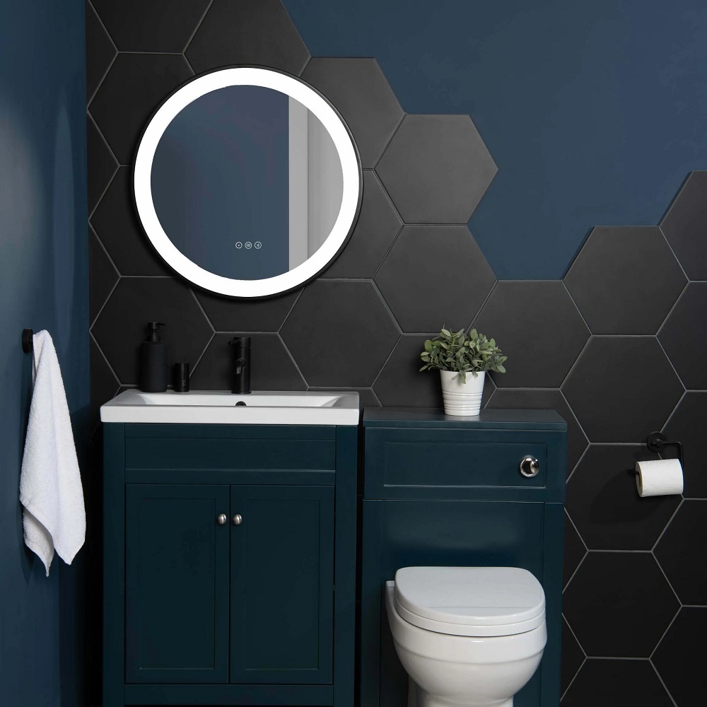 Matt black hexagon wall tiles across bathroom with basin vanity and toilet attached to save space. 