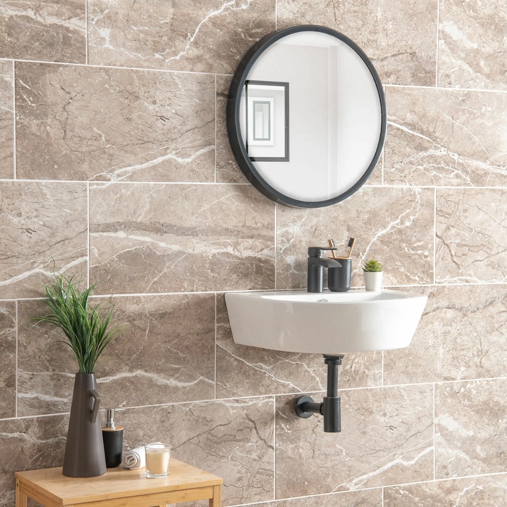 Natural stone effect bathroom wall tiles with wall mounted space saving basin and matt black metal hardware.