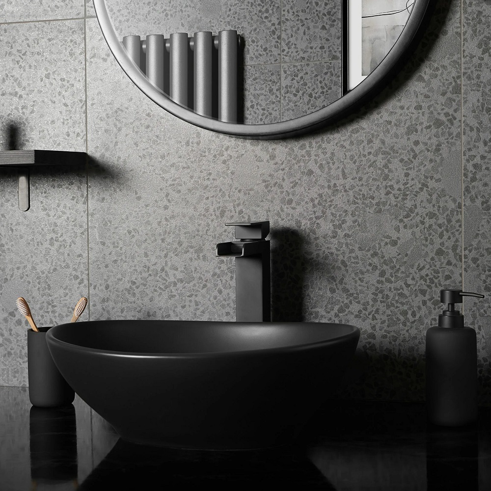 Black terrazzo splashback in cloakroom with all matt black bathroom accessories.