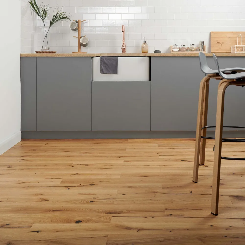 grey kitchen cabinets with white metro splashback and wood effect engineered flooring. 