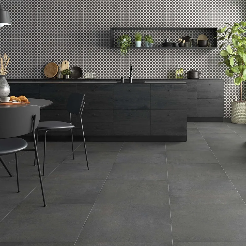 Matt black kitchen scheme with matt black dining room table and black and white splashback tiles behind worktops.