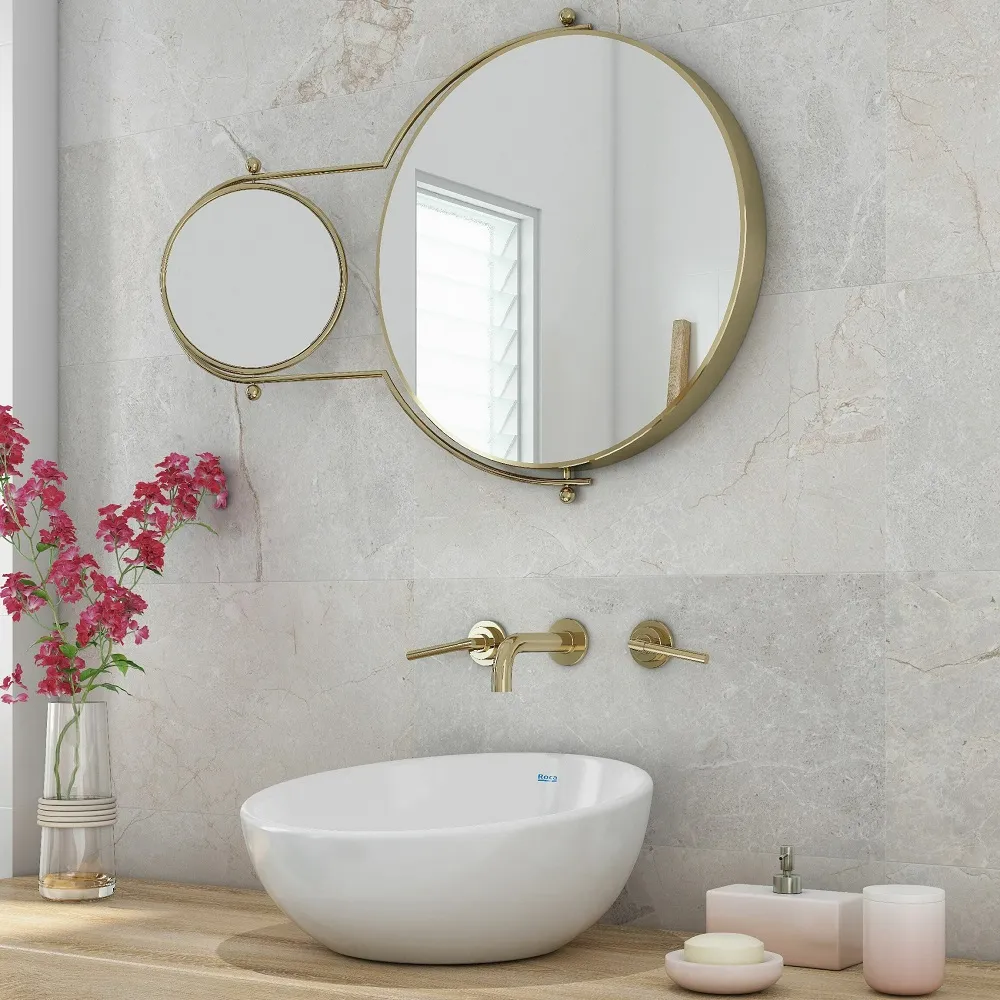 a sink and mirror on a wooden table with gold hardware